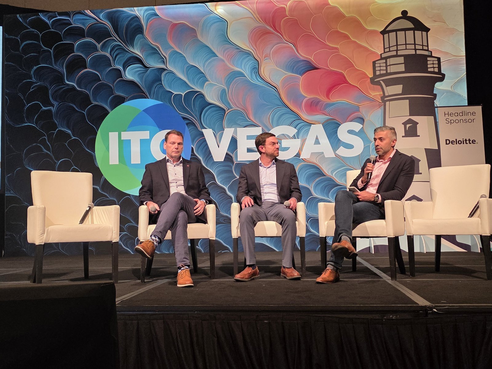 Tim Lewis of Travelers, Jesse Heller of Liberty Mutual and Zaheer Hooda of Applied Systems on stage at ITC Vegas 2026 discussing AI-powered connectivity in commercial insurance distribution.